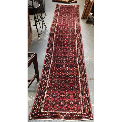 960 - A red ground runner rug, 350x63cm