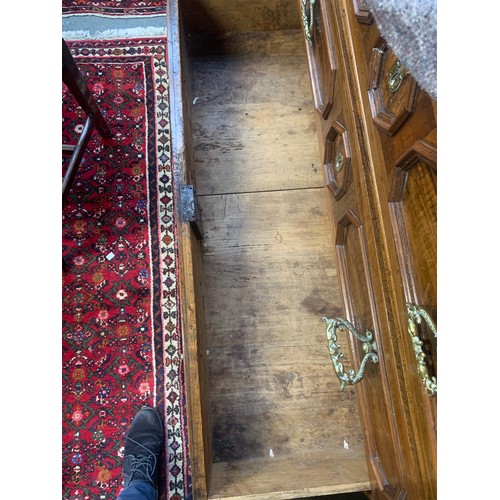 1323 - A massive 17th century Italian walnut chest of drawers, heavily moulded top over three drawers with ... 