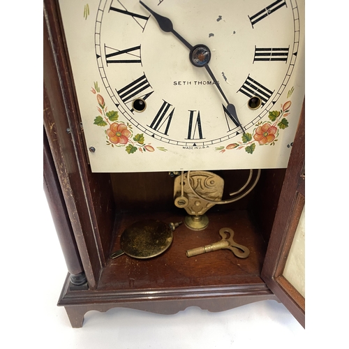 140 - An American mantel clock by Seth Thomas, the door glazed with a print of Independence Hall, Philadel... 