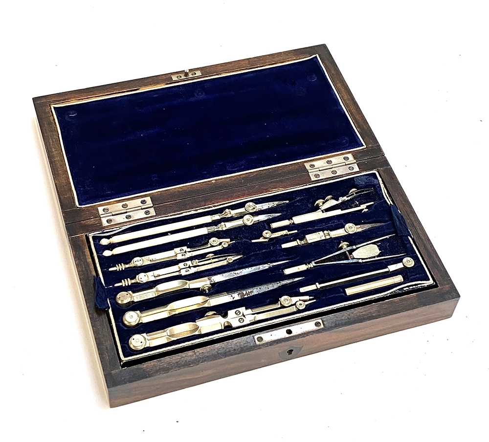 A mahogany cased set of drawing instruments with blue velvet interior ...