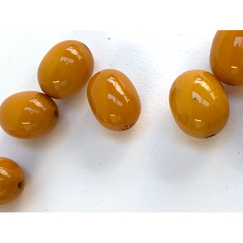 28 - A bakelite bead necklace in need of restringing, the beads each approx. 1.9cm, gross weight 116g