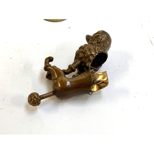 384 - A mixed lot to include a novelty brass poodle cigar cutter; painted spelter budgie; porcelain lady p... 