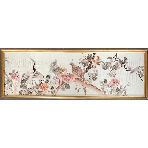 919 - An Oriental silk panel depicting birds amongst foliage, 35x112cm