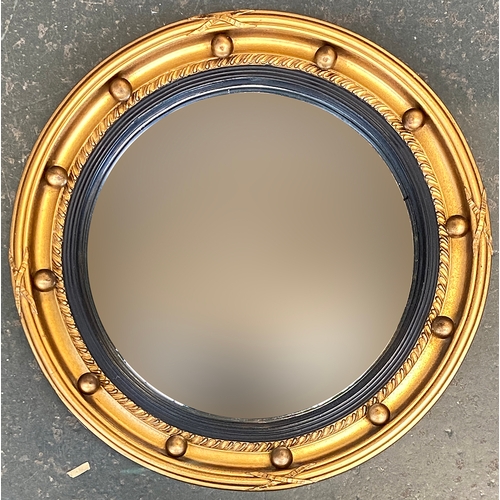 911 - A Regency style convex mirror with gilt frame and bobble moulding, 41cmD