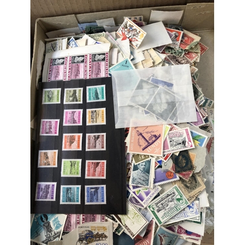 530 - A large quantity of stamps and accessories in four boxes to include loose stamps, stock books and al... 