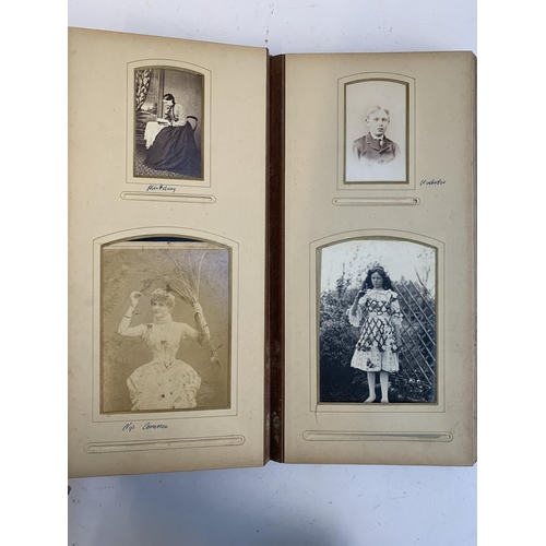 534 - A Victorian photograph album containing a quantity of black and white photographs, late nineteenth a... 