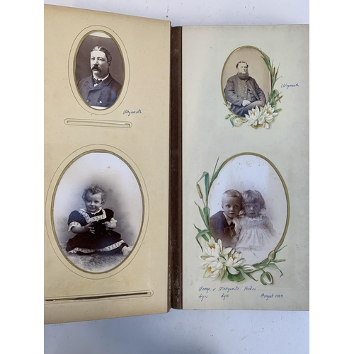 534 - A Victorian photograph album containing a quantity of black and white photographs, late nineteenth a... 