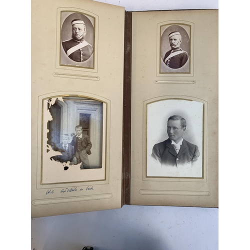 534 - A Victorian photograph album containing a quantity of black and white photographs, late nineteenth a... 