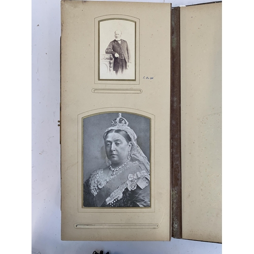 534 - A Victorian photograph album containing a quantity of black and white photographs, late nineteenth a... 