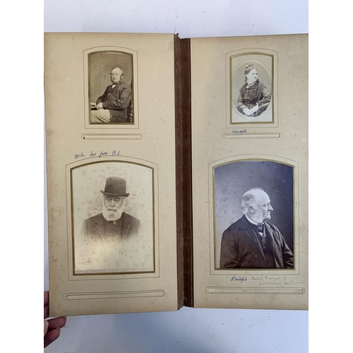 534 - A Victorian photograph album containing a quantity of black and white photographs, late nineteenth a... 