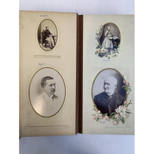 534 - A Victorian photograph album containing a quantity of black and white photographs, late nineteenth a... 