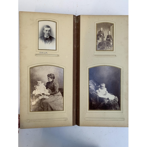 534 - A Victorian photograph album containing a quantity of black and white photographs, late nineteenth a... 