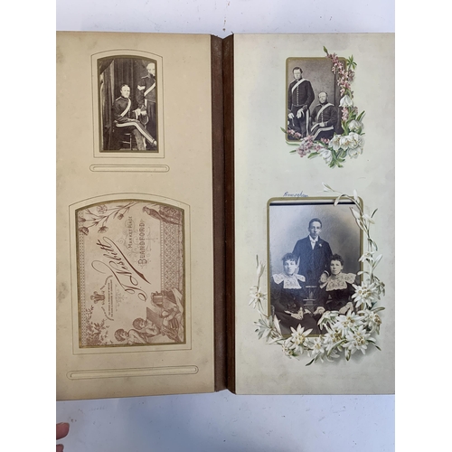 534 - A Victorian photograph album containing a quantity of black and white photographs, late nineteenth a... 