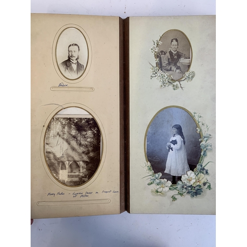 534 - A Victorian photograph album containing a quantity of black and white photographs, late nineteenth a... 