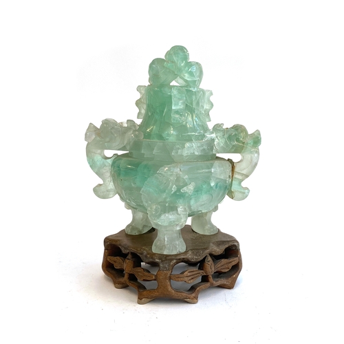 585 - A Chinese carved fluorite censer (af), the lid in the form of a dragon, on a carved wooden base, 18c... 