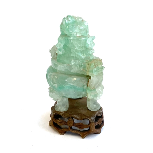 585 - A Chinese carved fluorite censer (af), the lid in the form of a dragon, on a carved wooden base, 18c... 