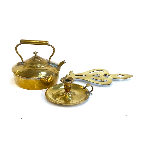 616 - A 19th century brass kettle, candlestick and a trivet