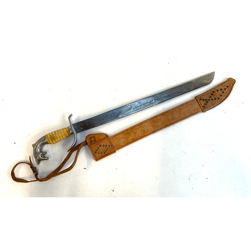 618 - A reproduction Mexican sword, with leather sheath, 64cmL overall