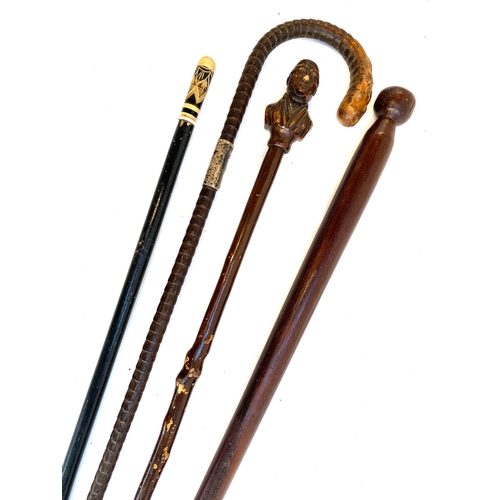 629 - Four walking canes, one with silver collar