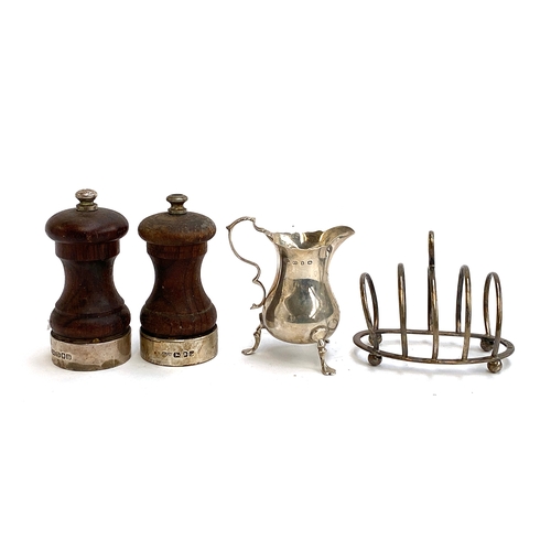 97 - A four division silver toast rack by George Unite, Birmingham 1914; a milk jug by the same maker, Bi... 