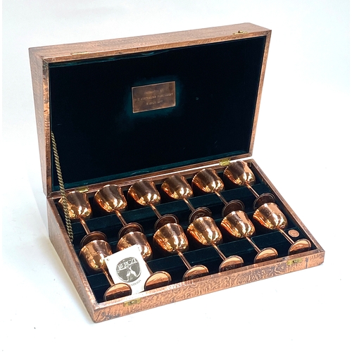 496 - A cased set of 12 Berczi Australian copper goblets, each 12cmH, the case bearing a plaque engraved '... 