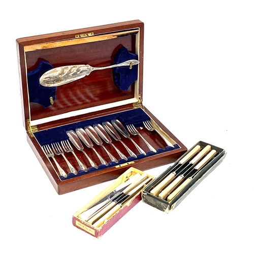 115 - A mahogany canteen of fish knives and forks, together with 12 resin handled stainless steel knives