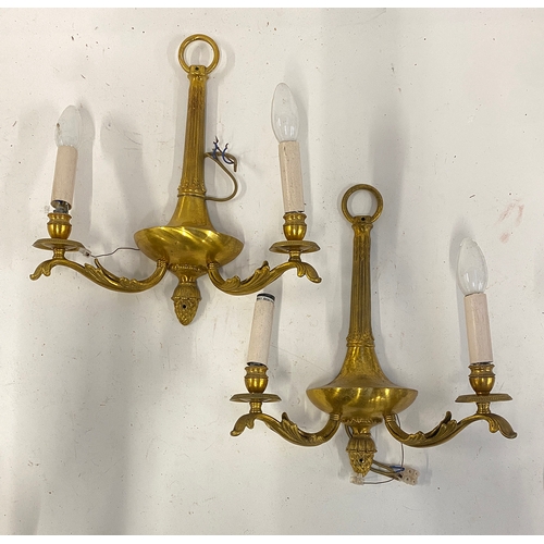 517 - A pair of brass twin arm wall sconces, with acanthus detail, 40cmH