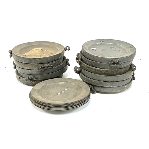 519 - A quantity of pewter warming dishes and plates