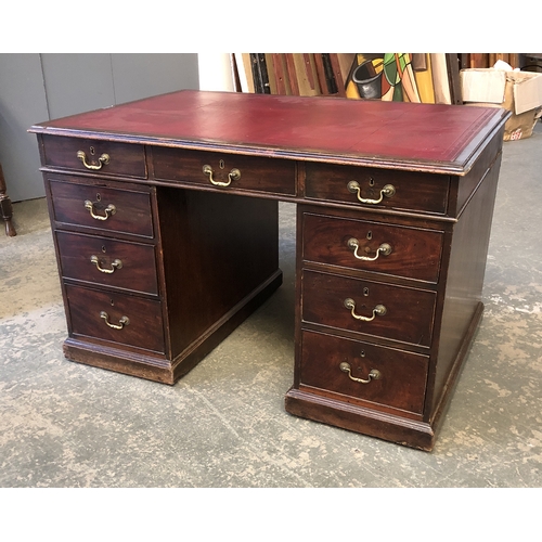 1201 - A 19th century pedestal desk, with red leather skiver, over nine drawers, on a plinth base, 125x85x7... 