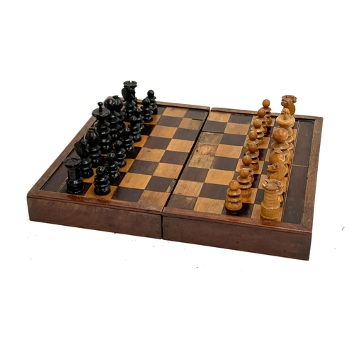 327 - A folding chess/backgammon board, with large chess pieces, the board 44x38cm; together with a quanti... 