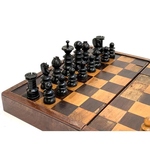 327 - A folding chess/backgammon board, with large chess pieces, the board 44x38cm; together with a quanti... 