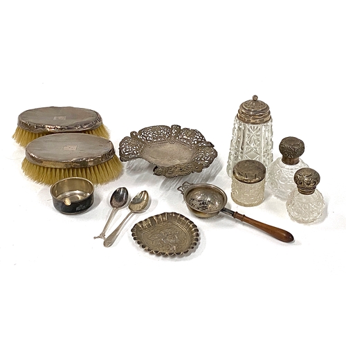 93 - A mixed lot of silver to include two clothes brushes (AF); cherub pin dish; tea strainer; various cu... 