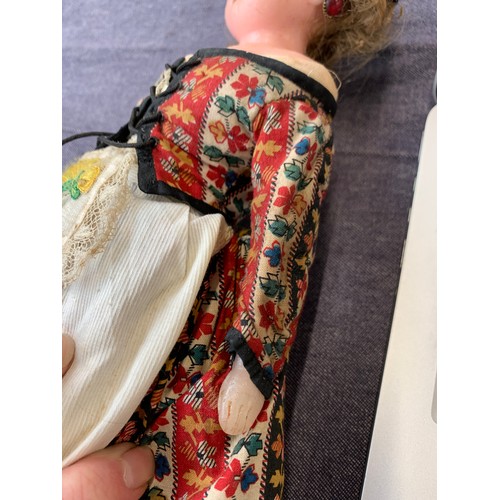 516 - A late 19th/early 20th century wax doll, 26cmL