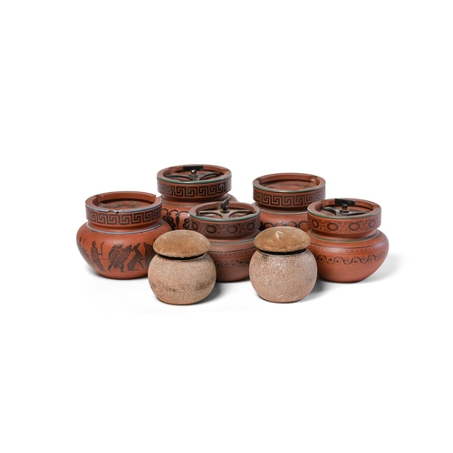 103 - A quantity of 19th century English red stoneware Comprising five black encaustic decorated ashtrays ... 