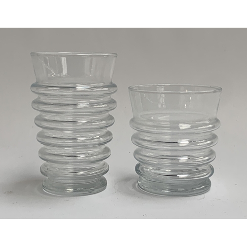 113 - A quantity of glass tumblers of ribbed form, the taller 13cmH (11), the shorter 9.5cmH (8)