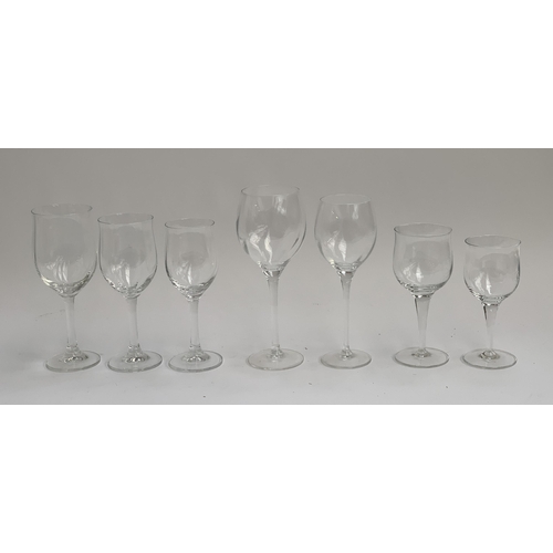 114 - A large quantity of wine glasses comprising three different designs: slightly lobed design, the larg... 