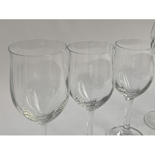 114 - A large quantity of wine glasses comprising three different designs: slightly lobed design, the larg... 