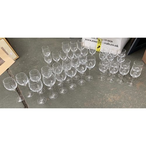 114 - A large quantity of wine glasses comprising three different designs: slightly lobed design, the larg... 