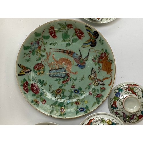 122 - A Chinese famille verte celadon plate, decorated with insects, precious objects and a phoenix, marks... 