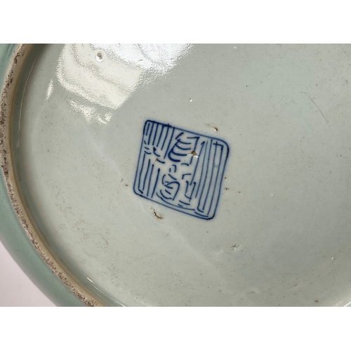 122 - A Chinese famille verte celadon plate, decorated with insects, precious objects and a phoenix, marks... 