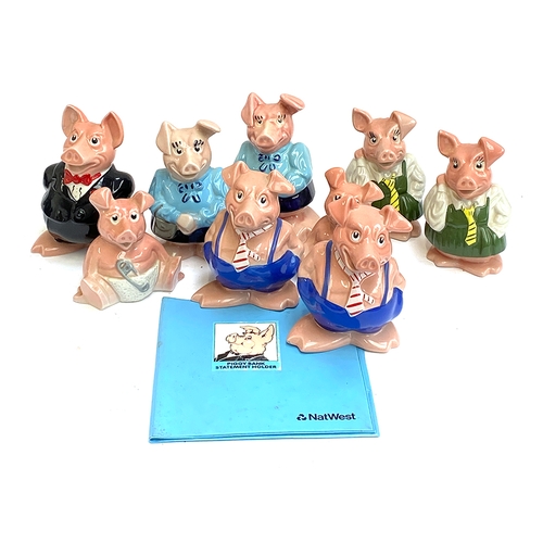 130 - A quantity of nine Wade piggy banks plus statement holder; together with a Poole pottery dolphin and... 