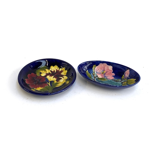 147 - A Moorcroft oblong dish with magnolia pattern, 23.5cmW; together with a further dish, 25cmD (2)