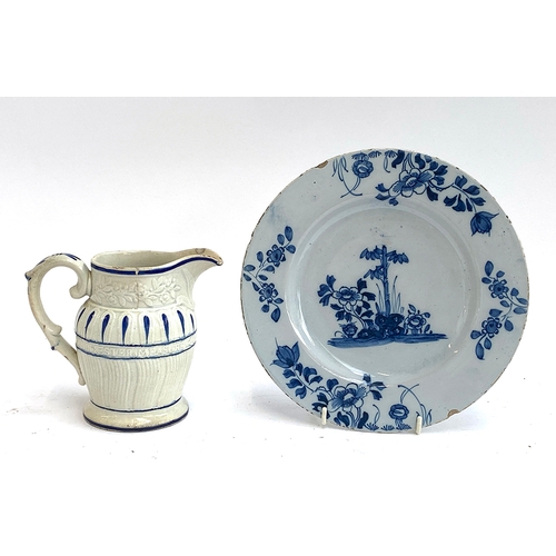 153 - An 18th century Delft plate, 23cmD; together with an early 19th century moulded Pearlware jug (af), ... 