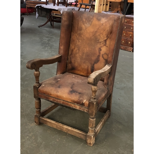 1096 - An oak and leather upholstered armchair in 17th century style, 64cmW