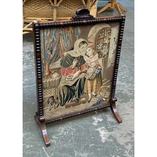 1097 - A 19th century rosewood fire screen (af), with shell cresting, needlework panel depicting mother and... 