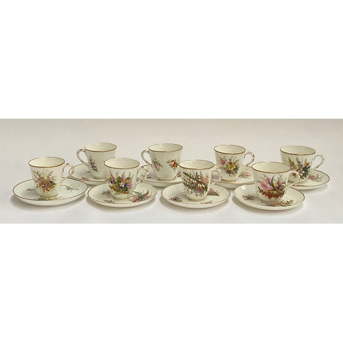 82 - A set of eight early 20th century hand painted porcelain coffee cups and saucers, floral spray desig... 