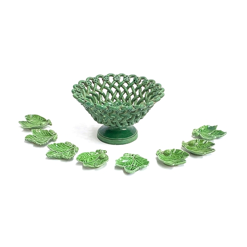 84 - A green glazed continental basket, 20cmD; together eight green glazed acorn leaf shaped pin dishes, ... 