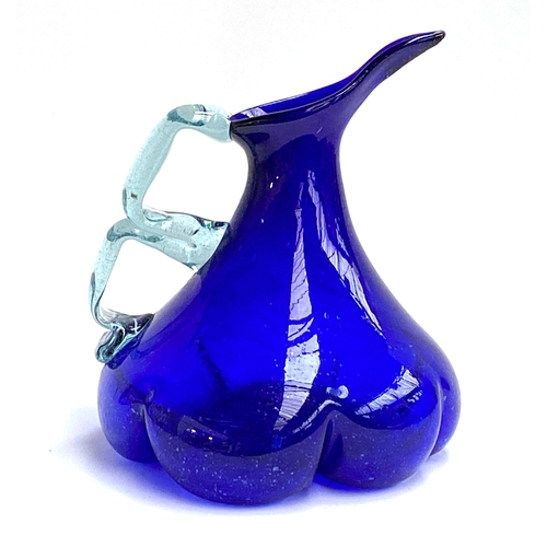 93 - Interior design interest: A large art glass jug, of lobed form with segmented handle, 25cmH