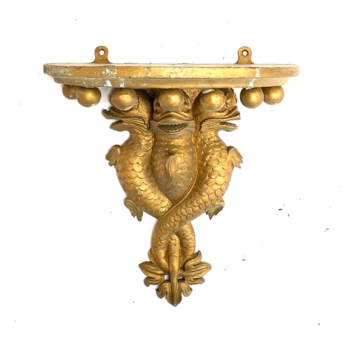 198 - A gilt painted gesso wall bracket, three entwined dolphins with bobble moulding, 31cmH