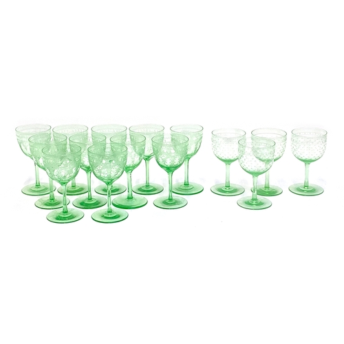 70 - A set of 11 green tint wine glasses with etched decoration, 12.5cm high; together with a further fou... 